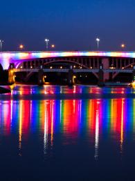 Minneapolis bridge lit up with pride colors.