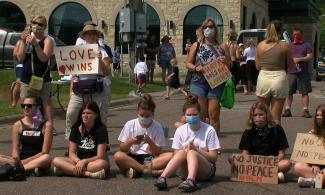 A group of protesters holding anti-white supremacist signs